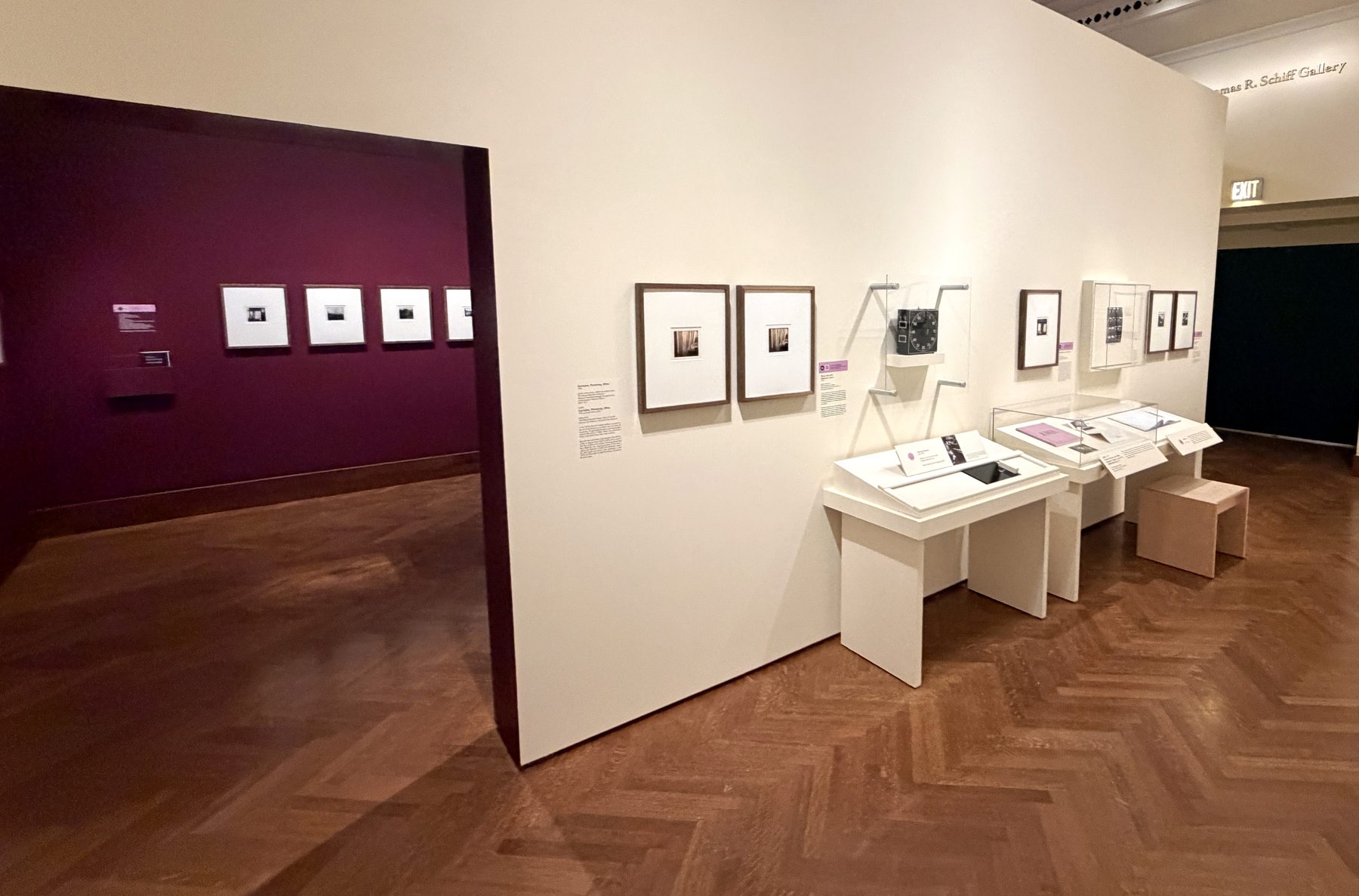 Gallery view of the exhibition with the scent station among framed photographs